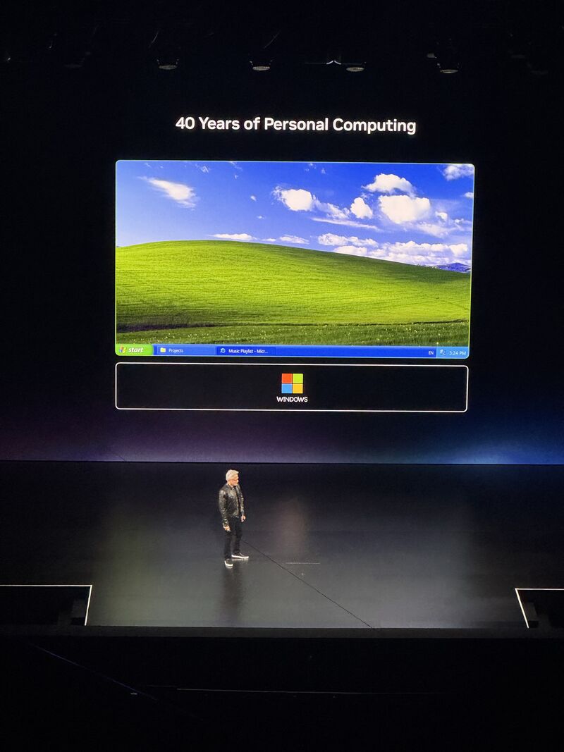 Jensen Huang on stage at Computex 2026 with a slide reading "40 Years of Personal Computing" showing the classic Windows XP desktop